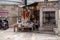 Eklingji, India - March 15, 2020: Vendor sits at his market stall stand, selling, books, trinkets and jewelry, waiting for