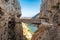 El Caminito del Rey walkway along the steep walls of a narrow gorge in El Chorro with spectacular stone bridge, Spain.