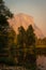 El Capitan lit up by setting sun and Merced River in foreground