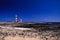 El Cotillo - Faro del Toston: View over dunes and rocky ground on red and white striped lighthouse in north of Fuerteventura