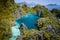 El Nido, Palawan, Philippines. Aerial drone view of beautiful big lagoon surrounded by karst limestone cliffs. Tourists