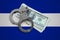 El Salvador flag with handcuffs and a bundle of dollars. Currency corruption in the country. Financial crimes
