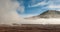 El Tatio, Atacama, Chile. Active geysers comes out of the ground. Hot vapor erupting activity, thick flume of steam.