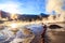 El Tatio Geyser site, San Pedro de Atacama with tourists visiting. Photographer at El Tatio geysers, Chile at sunrise