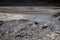 El Tatio geysers in Atacama desert, Chile: Close up of geyser hole splashing hot water