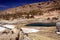 El Tatio geysers in Atacama desert, Chile: View on hot natural blue pool, getting blue color from silica