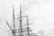 Elaborate rigging on a three mast tall ship against a gray sky