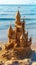 An elaborate sand castle stands on the sandy shore by the waters edge, blending into the natural landscape as a stunning