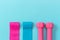 Elastic expanders and pink dumbbells on blue background copy space