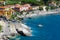 Elba Island, Italy. June 25, 2016: Seashore with beach and rocks and rocky slope of the Island of Elba in Italy. Many people on