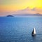 Elba island sunset view from Piombino an sail boat. Mediterranean sea. Italy