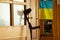 An elbow crutch stands near the door in the apartment and on the background of the flag of Ukraine, rehabilitation after