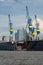 Elbphilharmonie in Hamburg harbor between some cranes at the docks