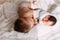 elder brother kissing newborn baby sister