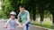 The elder brother teaches his sister how to ride a bicycle, the first successes of children