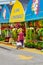 Elder Canadian woman looking at the flowers at the greenhouse flower shops at Atwater market