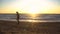 Elder Fisherman in Hat fishing at sunrise on the Coast of the Sea at Windy Weather