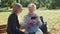 Elder grandmother showing her granddaughter photos on smartphone