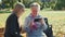 Elder grandmother showing her granddaughter photos on smartphone