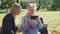 Elder grandmother showing her granddaughter photos on smartphone