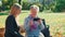 Elder grandmother showing her granddaughter photos on smartphone