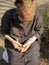 Elder old woman harvesting and cleaning dried beans