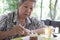 Elder senoir eating chocolate mousse cake at cafe. elderly woman