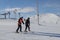 A elder trainer teaches a man skiing