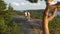 Elderly active couple climbing on the rock and admiring the sunrise, the sunset.