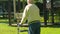 Elderly active senior with walker in the garden