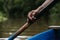 Elderly African-American male rowing a boat on a river