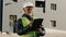 Elderly african american man construction manager evaluates building old foreman standing on street in protective