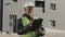 Elderly african american man construction manager evaluates building old foreman standing on street in protective