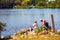 Elderly angler Canadian couple sitting near the riverside and fishing in lachine rapids park, Montreal, Quebec, Canada