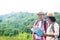 Elderly Asian couples traveling in the forest carrying maps