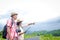 Elderly Asian couples traveling in the forest carrying maps