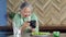 Elderly Asian woman taking photos of food in her kitchen at home