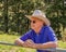 Elderly Australian farmer, looking over a fence into a paddock