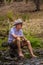 Elderly Australian man sitting by a creek