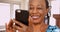 An elderly back woman swipes on her favorite dating app