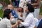 An elderly bearded Indian in a black turban gives a woman an acupressure of the hand