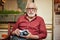 Elderly bearded male in glasses resting near his camper van