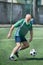 elderly bearded man playing football on field