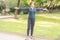 Elderly beautiful active happy woman in the morning in the autumn park doing sports exercises.