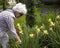 Elderly beautiful gray-haired woman in her garden
