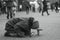 Elderly beggar woman begging on her knees on a city street. Beggars. Social problem