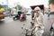 Elderly bicycle rickshaw looking for the passenger on the traffic street