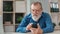 Elderly business male chatting surfing internet use smartphone at home office workplace