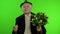 Elderly caucasian grandfather man with bouquet of flowers and ring goes on date