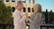 Elderly Caucasian married couple show love for each other near Colosseum in Rome